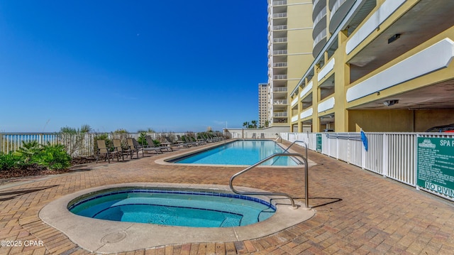 10519 Front Beach Rd Unit 1904B, Panama City Beach, FL 32407 - community pool featuring fence, a hot tub, and a patio area