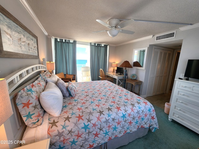 7205 Thomas Dr Unit E706, Panama City, FL 32408 - bedroom with crown molding, a textured ceiling, carpet floors, and a ceiling fan