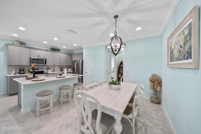 dining space with crown molding, recessed lighting, baseboards, and an inviting chandelier