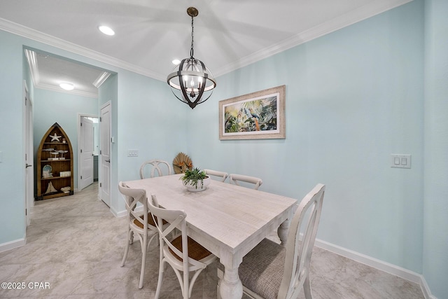 dining space with baseboards, a chandelier, and ornamental molding