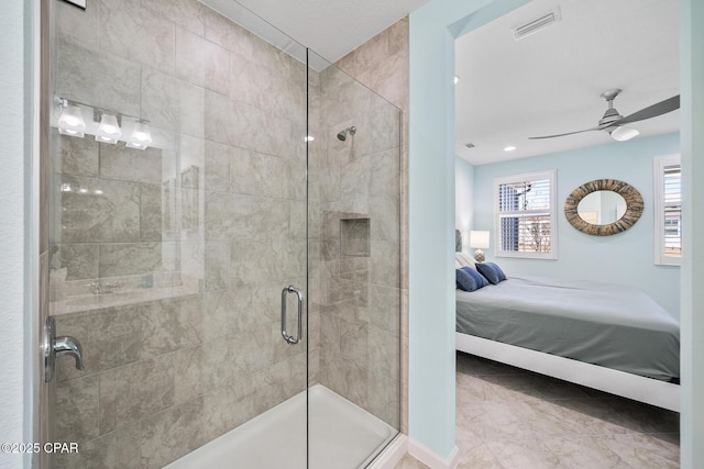 ensuite bathroom featuring ceiling fan, tile patterned flooring, baseboards, ensuite bathroom, and a stall shower