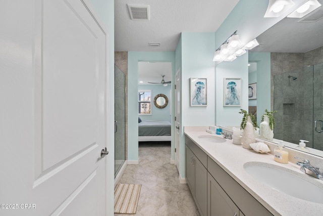 bathroom with visible vents, a sink, baseboards, and a stall shower