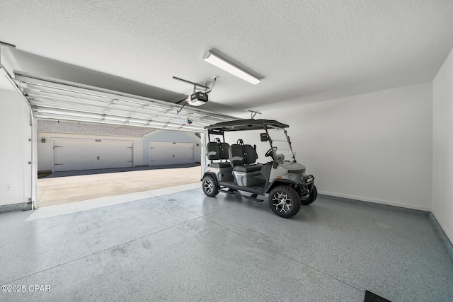 garage featuring baseboards and a garage door opener