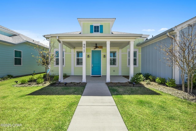 bungalow-style home with covered porch, board and batten siding, and a front yard