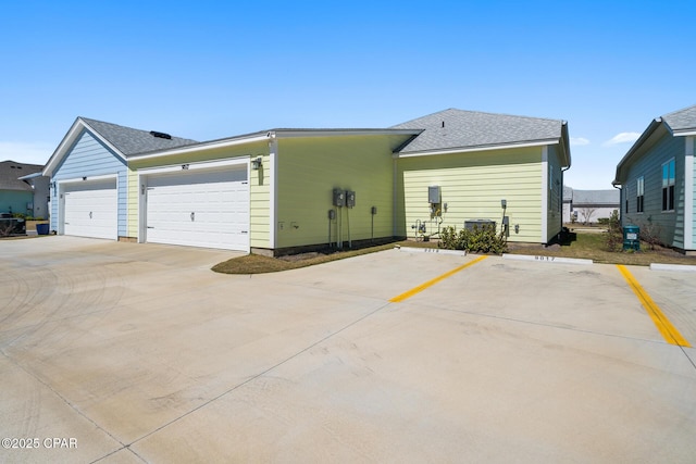 exterior space featuring roof with shingles