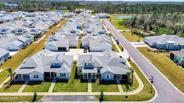 bird's eye view featuring a residential view and a water view