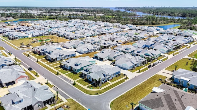 drone / aerial view with a water view and a residential view