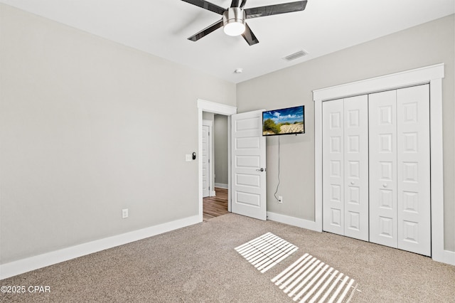 unfurnished bedroom with a closet, baseboards, visible vents, and carpet