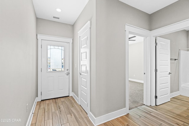 entrance foyer with light wood finished floors, baseboards, and visible vents