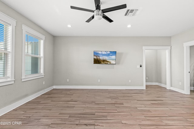 spare room with a ceiling fan, light wood-style flooring, baseboards, visible vents, and recessed lighting