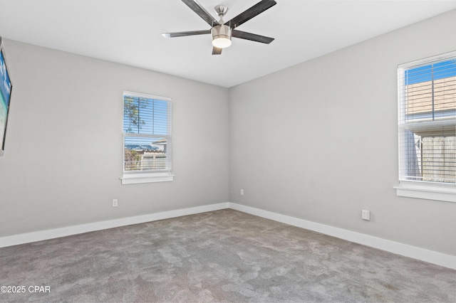 empty room featuring carpet floors, baseboards, and ceiling fan