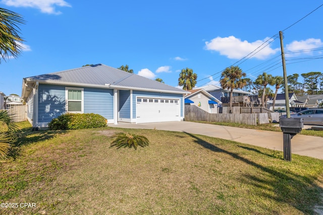single story home with metal roof, fence, an attached garage, a front yard, and driveway