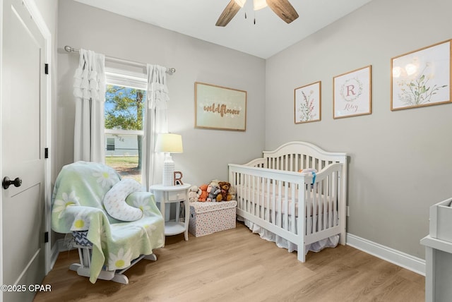 bedroom with baseboards, wood finished floors, and a ceiling fan