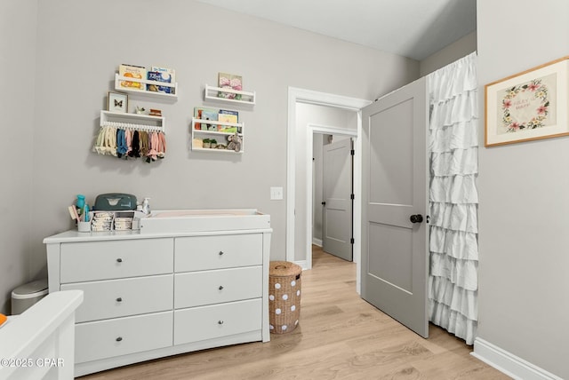 bedroom featuring baseboards and light wood-type flooring
