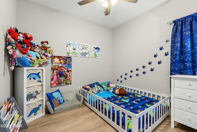 bedroom featuring a ceiling fan and wood finished floors
