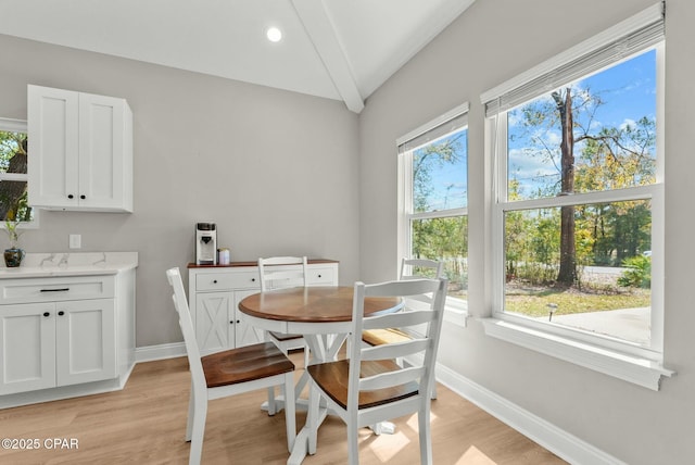 dining area with baseboards and light wood finished floors