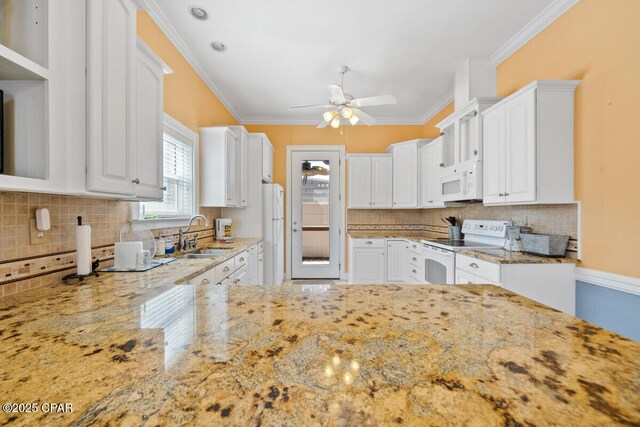 14205 Millcole Ave, Panama City Beach, FL 32413 - kitchen with light stone counters, white cabinetry, white appliances, tasteful backsplash, and ceiling fan