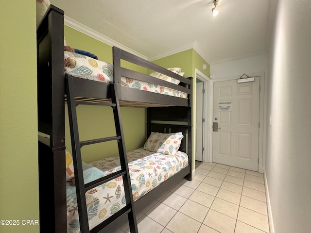 bedroom with tile patterned flooring and crown molding