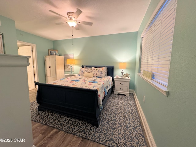 bedroom with baseboards, a ceiling fan, and wood finished floors