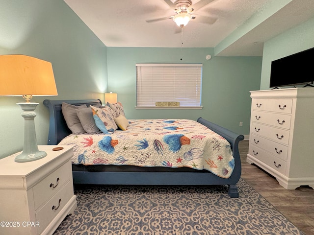 bedroom featuring baseboards, ceiling fan, and wood finished floors