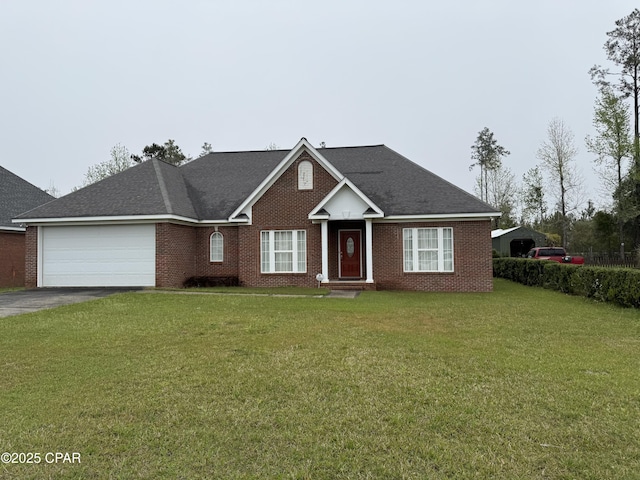 2557 Woods View Dr, Marianna, FL 32446 - view of front of home with driveway, a front yard, an attached garage, and brick siding