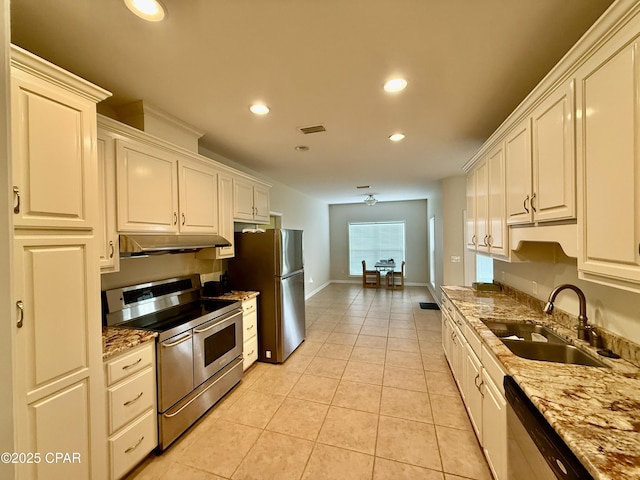 2557 Woods View Dr, Marianna, FL 32446 - kitchen featuring light tile patterned flooring, a sink, under cabinet range hood, stainless steel appliances, and visible vents