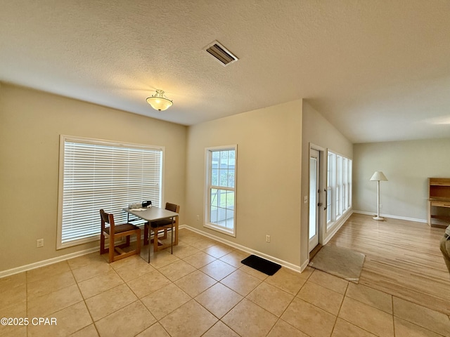 2557 Woods View Dr, Marianna, FL 32446 - dining area with light tile patterned flooring, a textured ceiling, baseboards, and visible vents