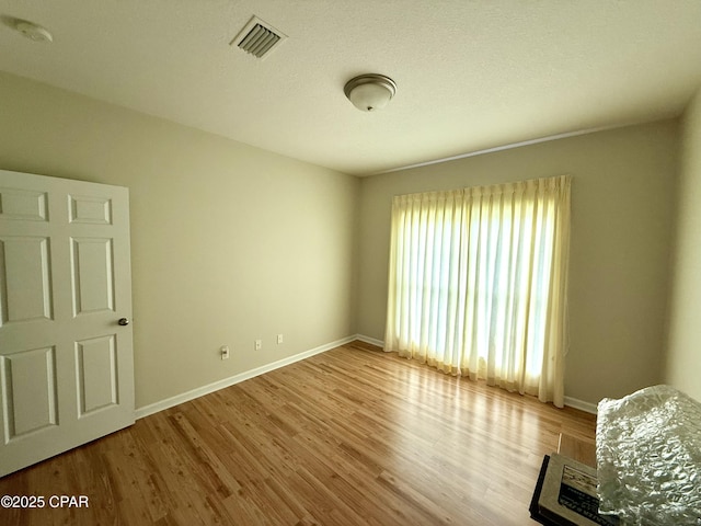 2557 Woods View Dr, Marianna, FL 32446 - empty room with baseboards, visible vents, and wood finished floors