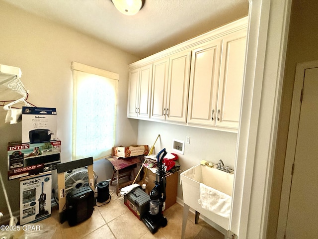 2557 Woods View Dr, Marianna, FL 32446 - clothes washing area with washer hookup, cabinet space, a sink, and tile patterned floors