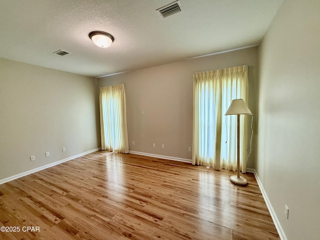 2557 Woods View Dr, Marianna, FL 32446 - spare room featuring wood finished floors, baseboards, and visible vents