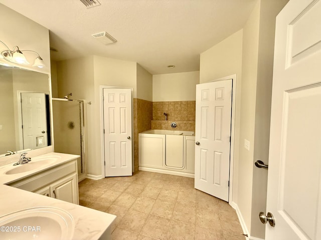 2557 Woods View Dr, Marianna, FL 32446 - full bath featuring vanity, baseboards, a shower stall, a garden tub, and visible vents