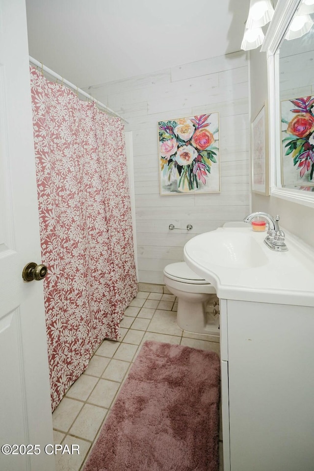 bathroom featuring toilet, tile patterned floors, vanity, and a shower with shower curtain