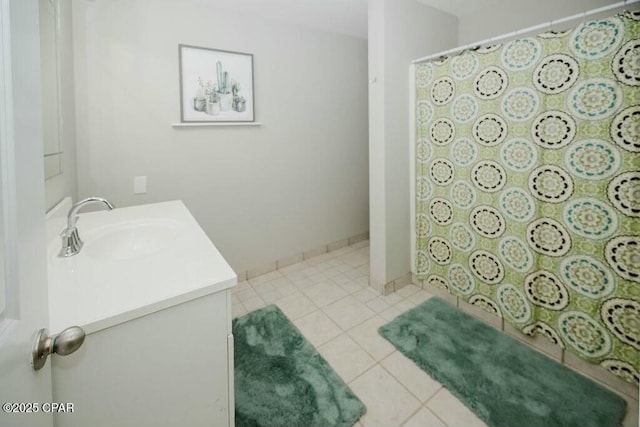 bathroom with tile patterned floors, vanity, baseboards, and a shower with curtain