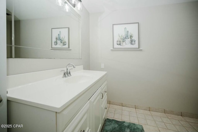 bathroom with tile patterned flooring, vanity, and baseboards
