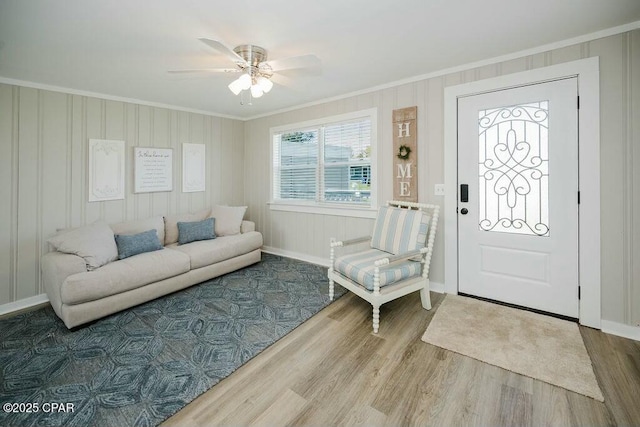 entrance foyer with ceiling fan, baseboards, crown molding, and wood finished floors