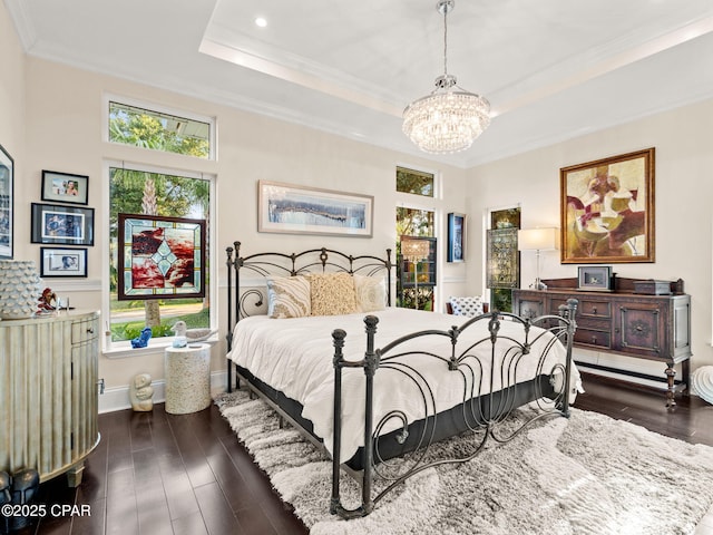 103 Harbour Pointe Dr, Lynn Haven, FL 32444 - bedroom with crown molding, a chandelier, a tray ceiling, dark wood-type flooring, and baseboards