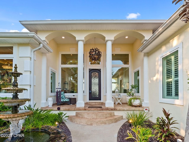103 Harbour Pointe Dr, Lynn Haven, FL 32444 - view of exterior entry with stucco siding and covered porch
