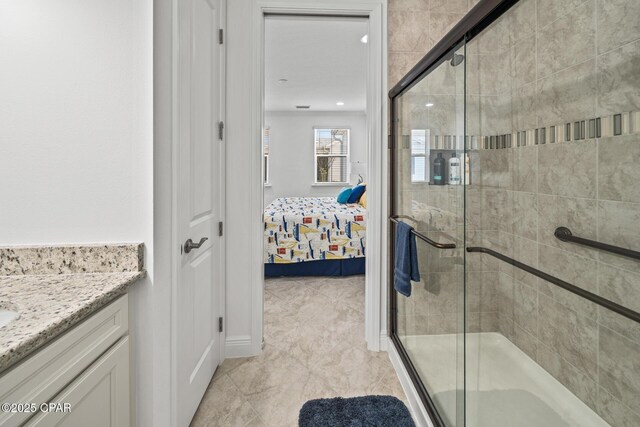 ensuite bathroom with a stall shower, vanity, and ensuite bathroom