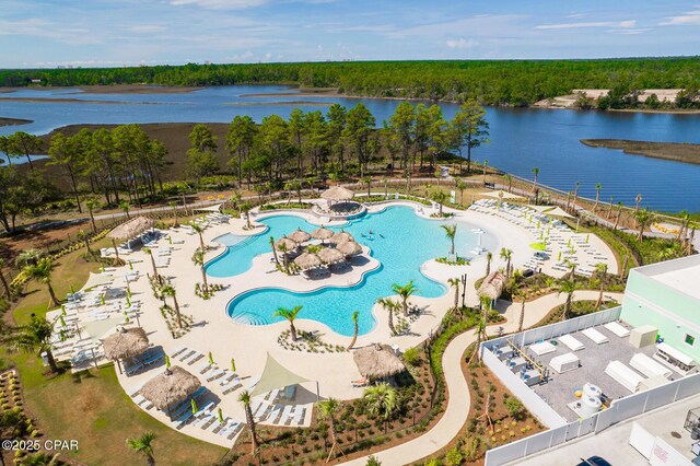 aerial view with a water view and a wooded view