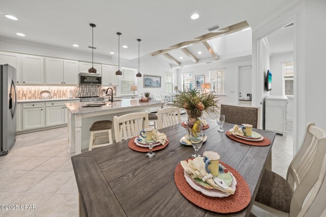 dining space with light tile patterned flooring, vaulted ceiling with beams, recessed lighting, and a wealth of natural light