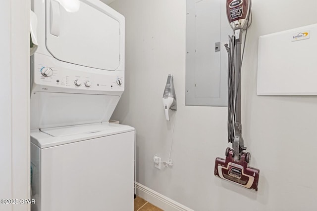 16701 Front Beach Rd Unit 1803, Panama City Beach, FL 32413 - laundry area featuring stacked washer and clothes dryer, electric panel, and baseboards
