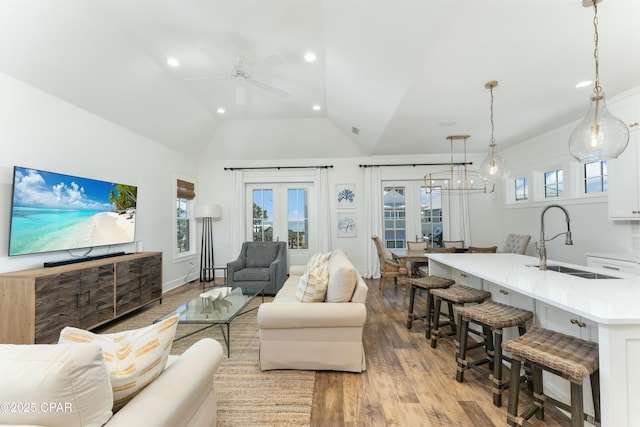 living area featuring ceiling fan, light wood-type flooring, and recessed lighting