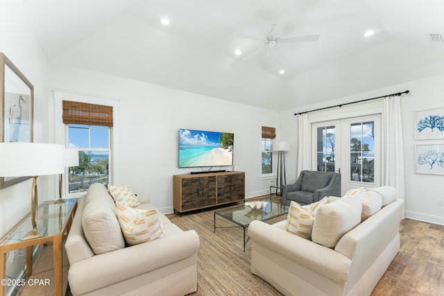 living room featuring recessed lighting, wood finished floors, a wealth of natural light, and vaulted ceiling