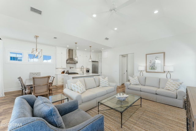 living area with recessed lighting, ceiling fan, visible vents, light wood-style flooring, and baseboards