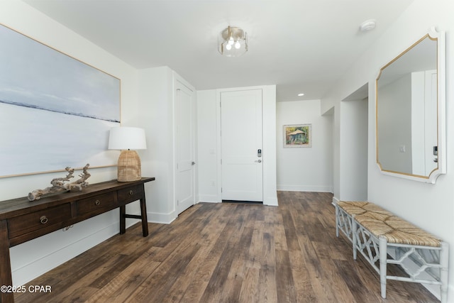 hallway with wood finished floors and baseboards