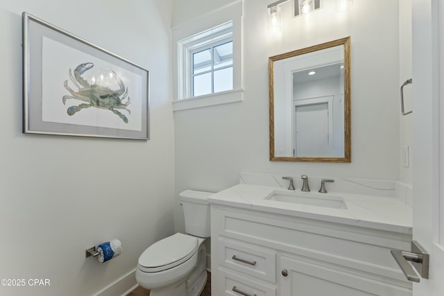 bathroom featuring toilet and vanity