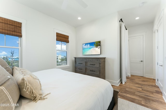 bedroom featuring recessed lighting, ceiling fan, wood finished floors, and baseboards