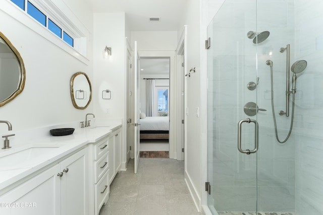 bathroom featuring plenty of natural light, a sink, and visible vents