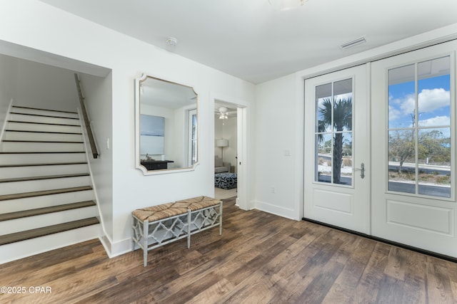entrance foyer featuring wood finished floors, stairs, visible vents, baseboards, and french doors
