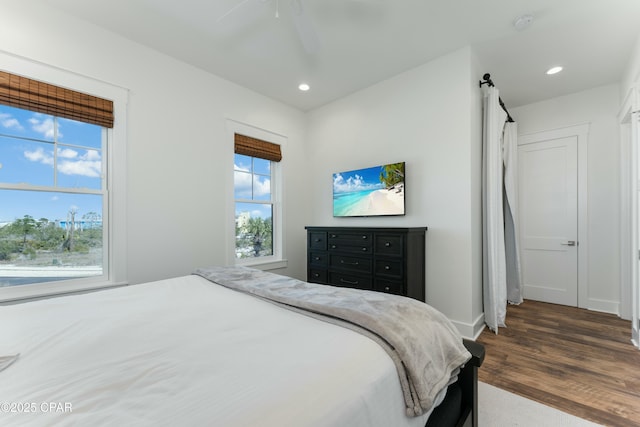 bedroom with baseboards, recessed lighting, wood finished floors, and ceiling fan